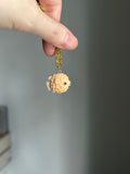 14k bail pufferfish in apricot shell carving