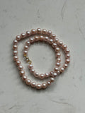 Genuine fresh water soft pink pearls 14k ends