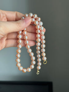 Genuine fresh water peachy pink pearls 14k ends