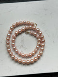 Genuine fresh water peachy pink pearls 14k ends