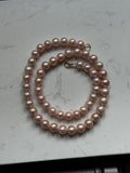 Genuine fresh water peachy pink pearls 14k ends