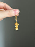 14k bail baby seahorse in gold mother of pearl shell carving