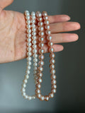 Genuine fresh water peachy pink pearls 14k ends