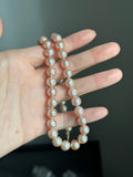 Genuine fresh water peachy pink pearls 14k ends