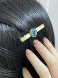 Bejewelled Hair Clip 9k solid gold with a blue topaz heart